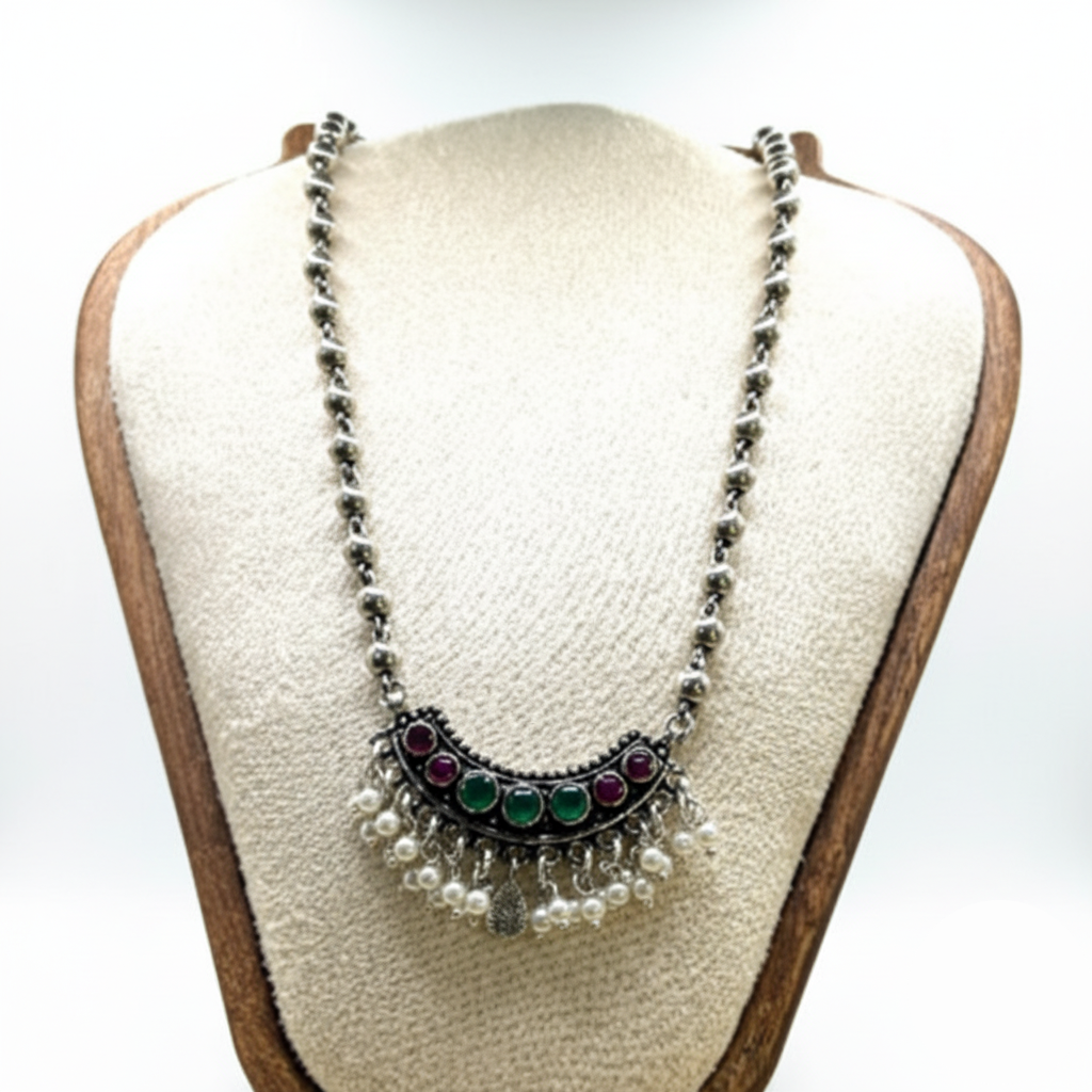 Necklace with beads and gemstones on a mannequin bust against a white background