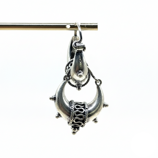 Silver pendant on a white background