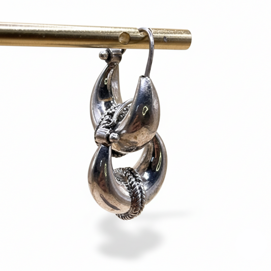 Silver earrings on a white background