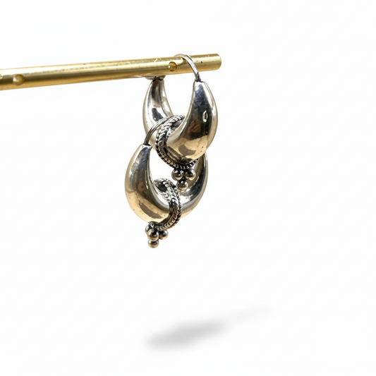 Silver hoop earrings on a white background