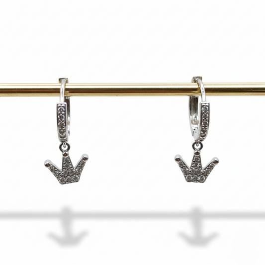 Silver hoop earrings with crown-shaped charms on a gold rod against a white background