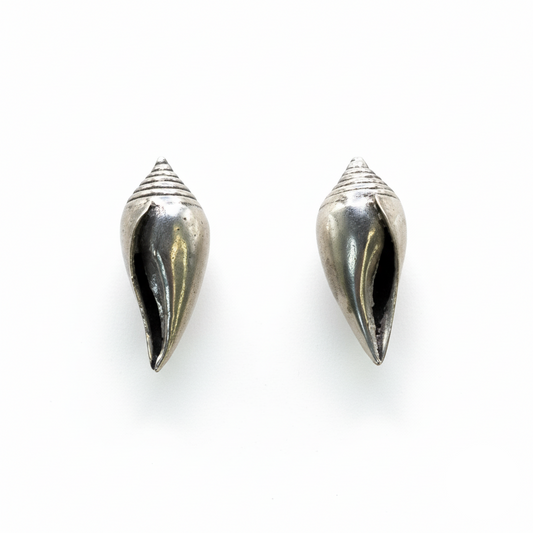 Pair of silver cone-shaped earrings on a white background