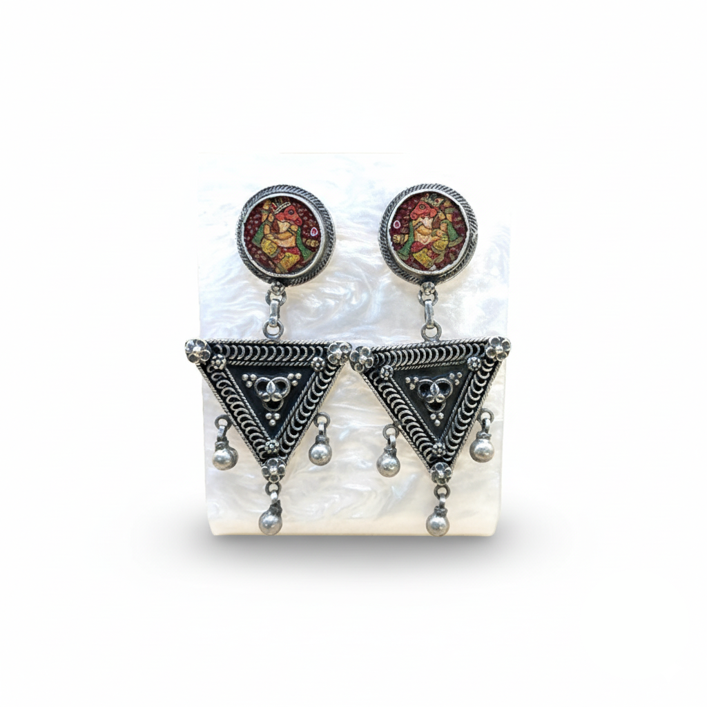 Pair of earrings with decorative elements on a white background