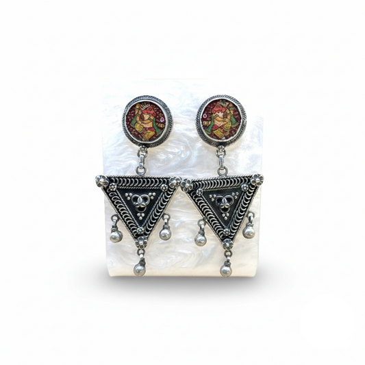 Pair of earrings with decorative elements on a white background