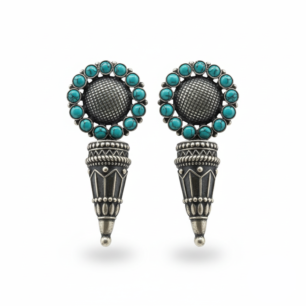 Pair of earrings with turquoise stones and silver accents on a white background