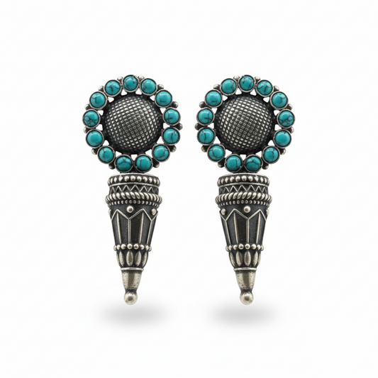 Pair of earrings with turquoise stones and silver accents on a white background