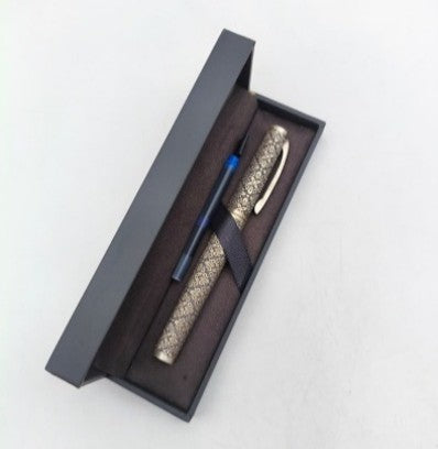 Pen with decorative cap in a black box on a white background