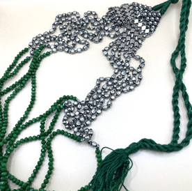 Green beaded necklace with silver clasp on a white background