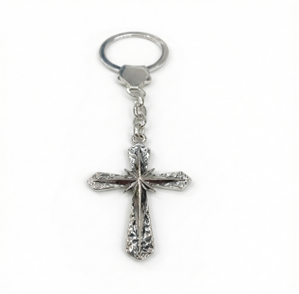 Silver cross keychain on a white background
