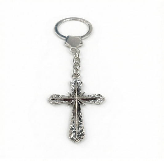 Silver cross keychain on a white background