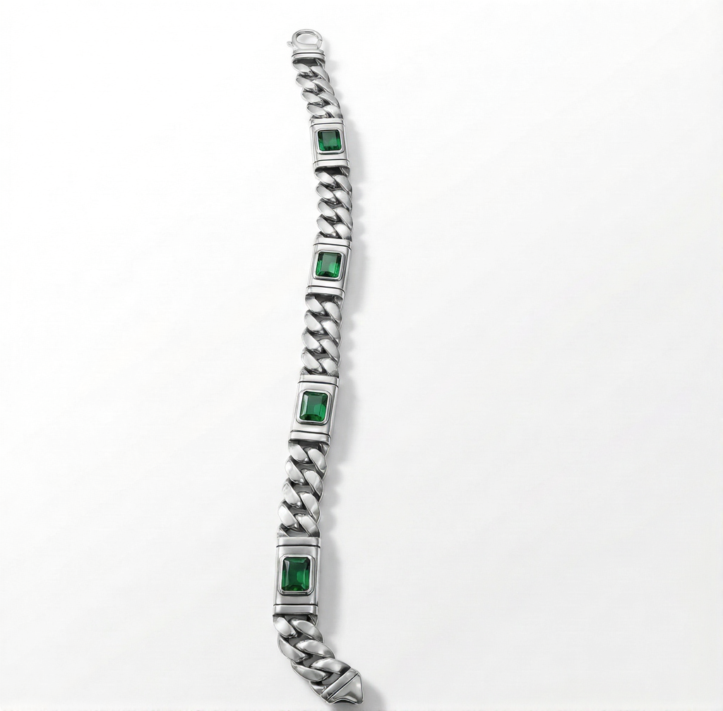 Silver bracelet with green gemstones on a white background