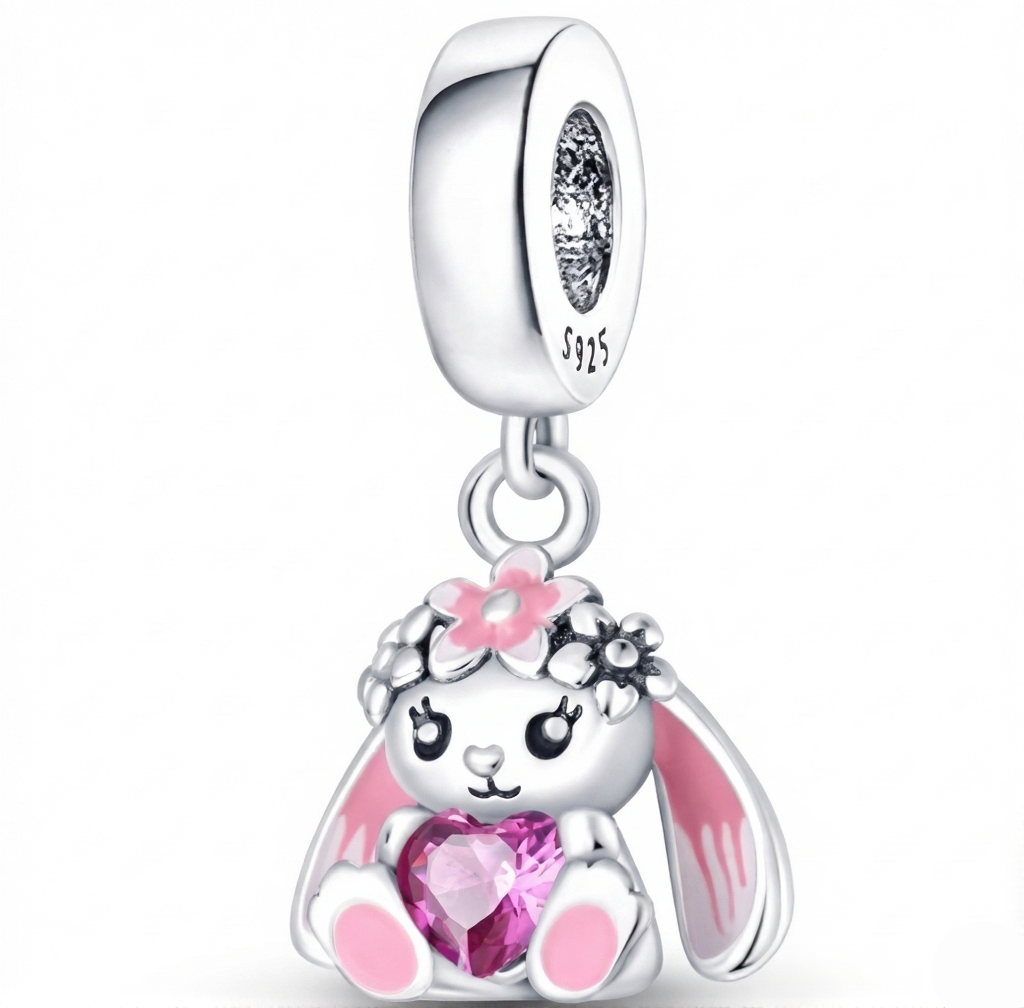 Silver charm with a pink bunny design and heart-shaped gem on a white background